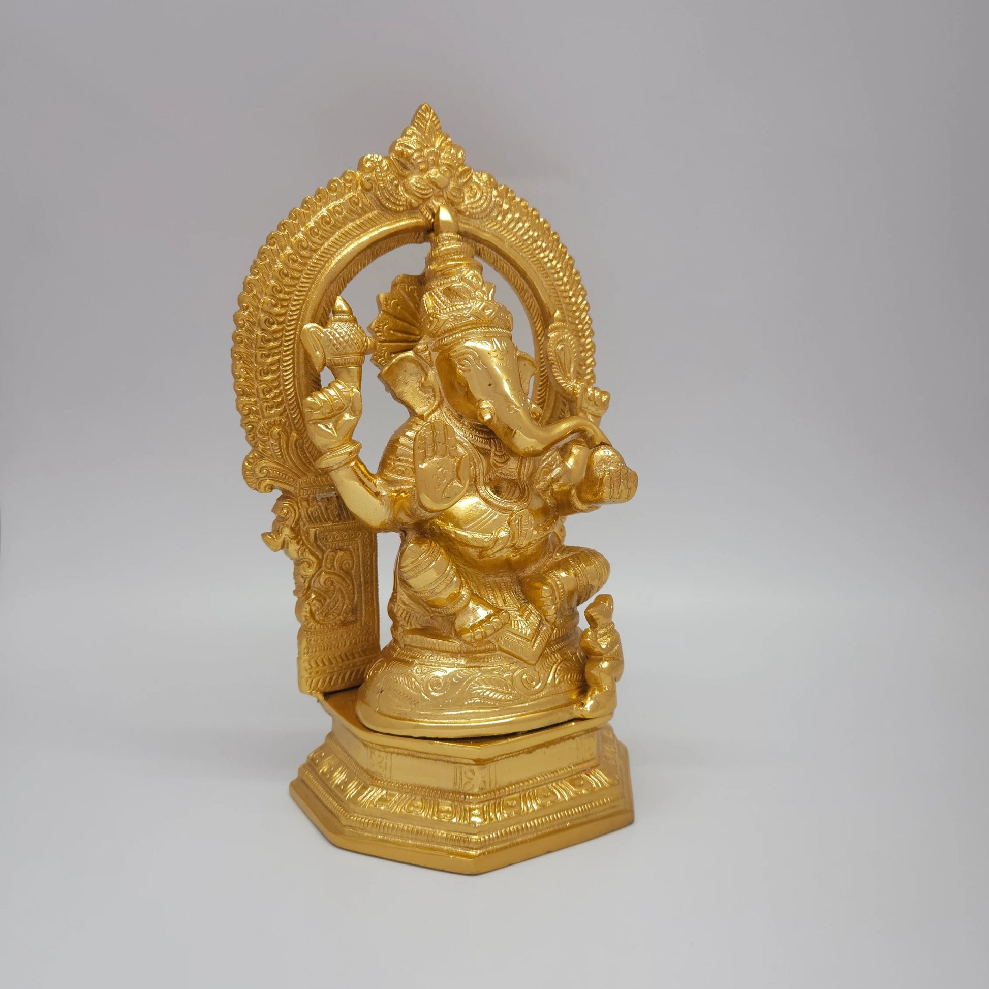 Right 45-degree close-up highlighting the trunk contour, the raised Abhaya blessing hand, and the polished metal side contours.