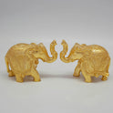 Symmetrical front face-to-face pairing layout of the decorative brass elephant couple showpiece set on a plain white studio background