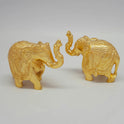 Diagonal procession view of the solid brass miniature elephant pair set highlighting the contrast between the raised and arched trunks
