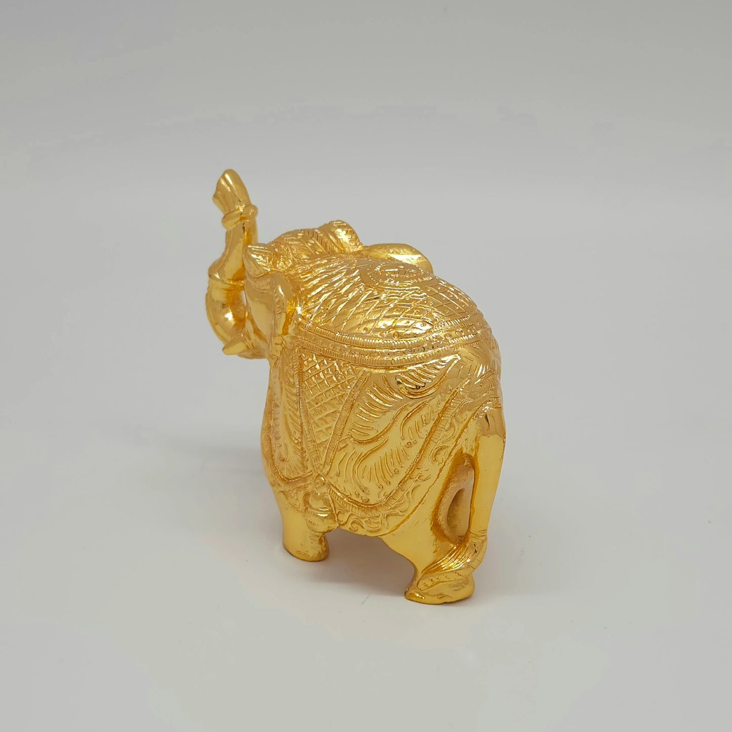 Rear perspective view of a single 8.5cm solid brass elephant showpiece highlighting the chiseled tail details and uniform satin gold finish