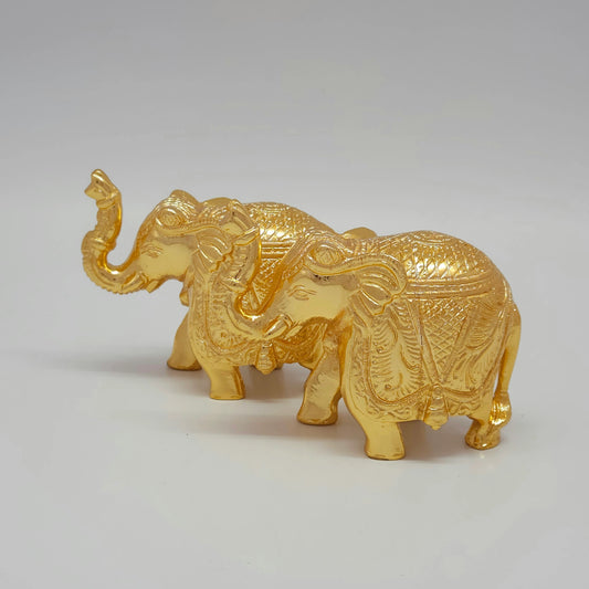 Flat left profile tiered group view of the 1.040kg solid brass elephant pair showcasing the beautiful alignment of the trunks and ceremonial saddlecloths