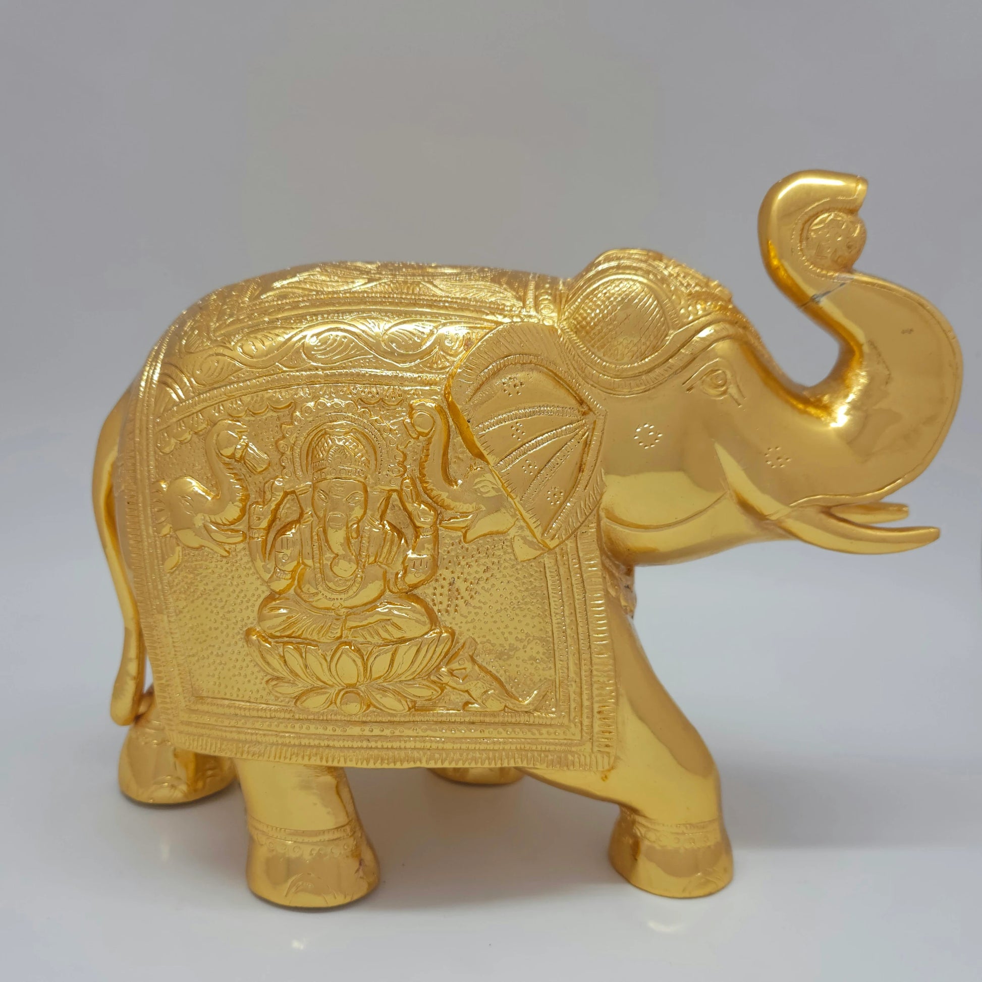 Flat right pose profile view highlighting the Gaja-Vinayagar engraving with two showering elephants on the saddle cloth of the 4.5kg showpiece