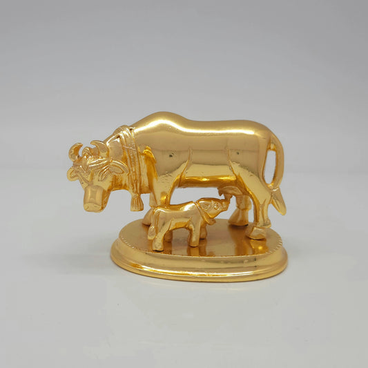 Flat straight front view of the 7cm compact high-gloss satin gold brass Kamadhenu cow and calf statue on a circular base