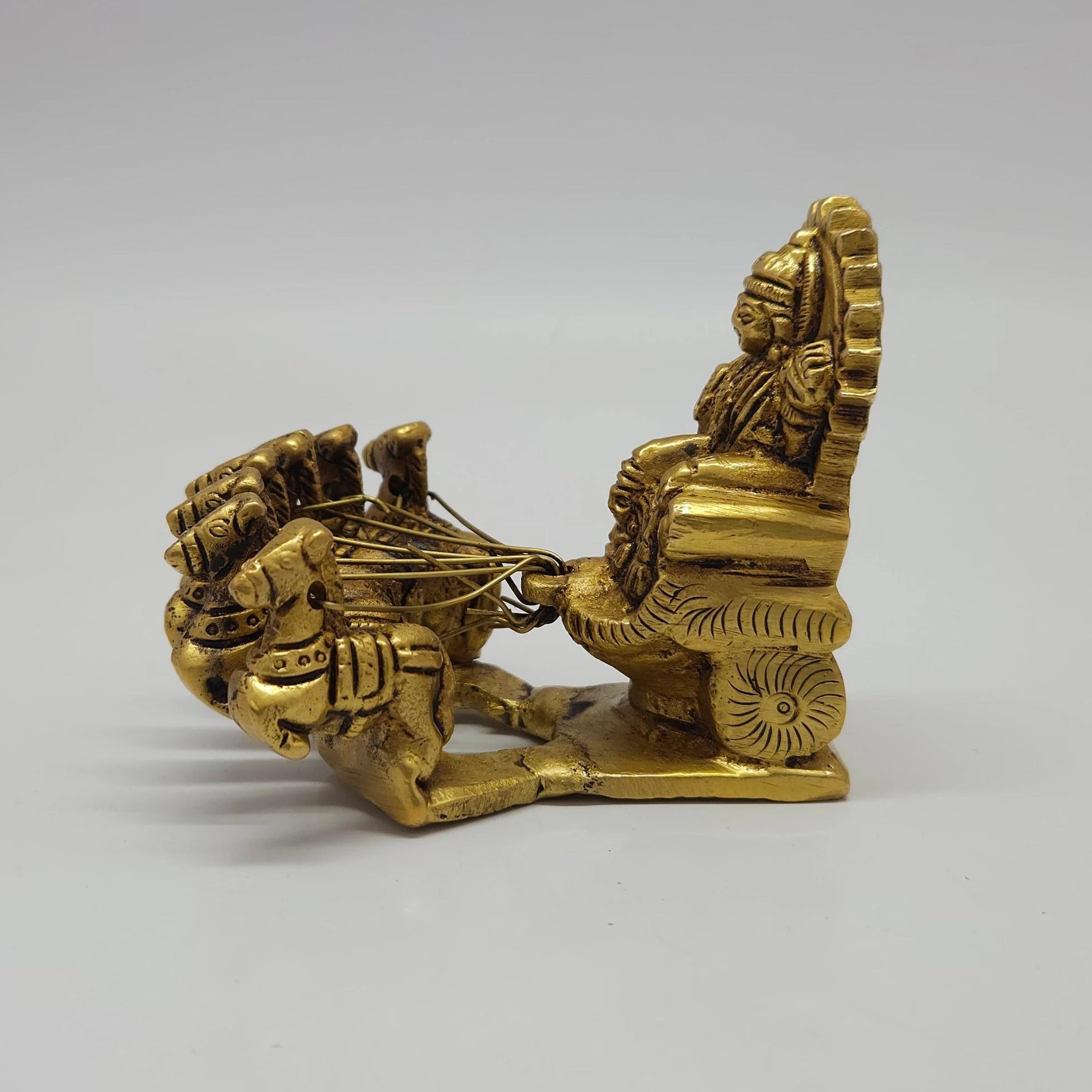 Complete side profile view showing the depth, carved chariot wheels, and horse hoof alignments