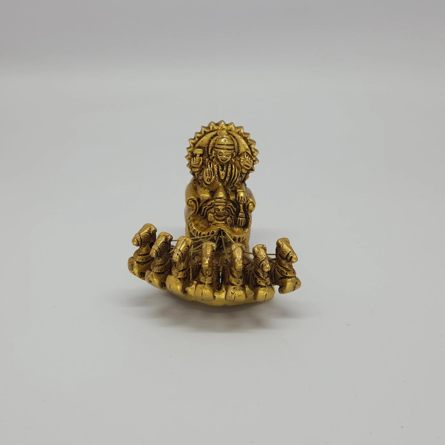 Flat straight front view showcasing the seven galloping horses and Lord Surya Deva crown symmetry