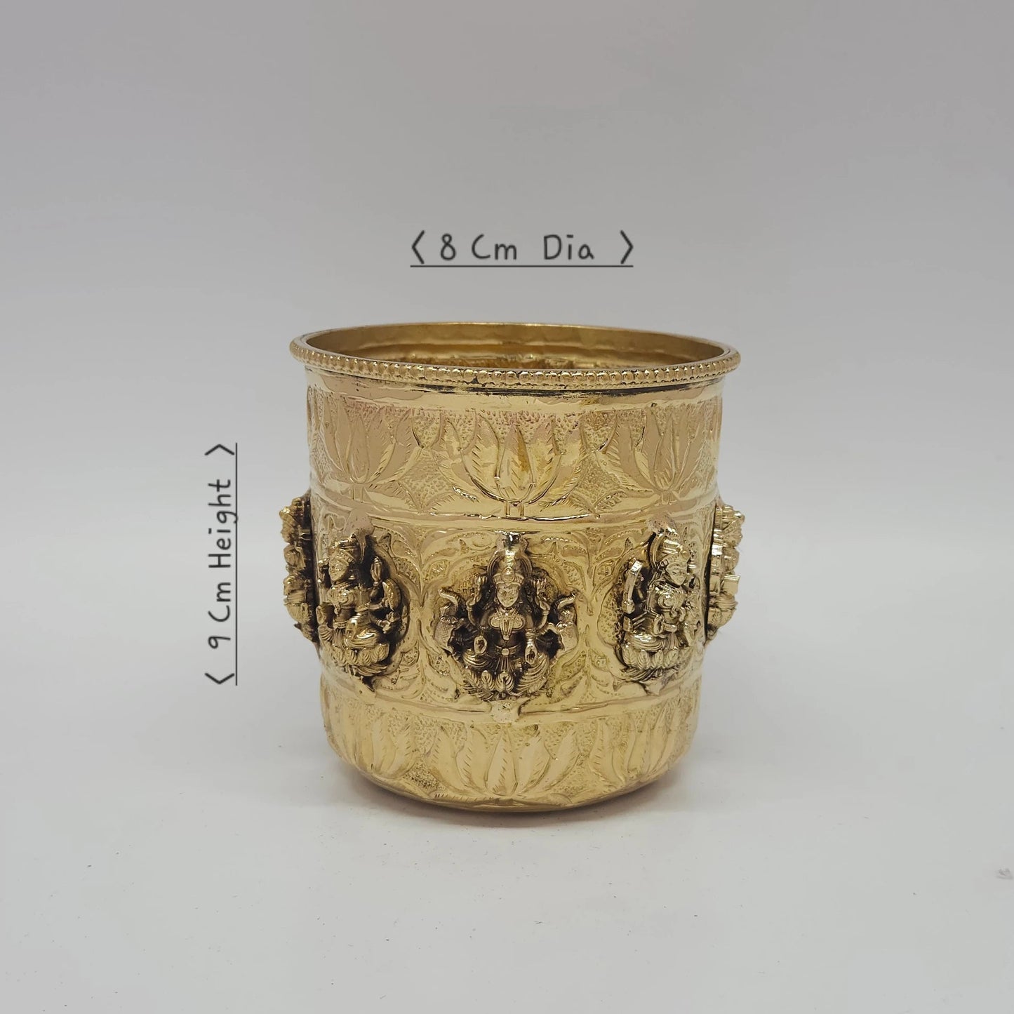 Traditional Hindu home mandir setup featuring the brass 3.5 Inch Mangal Ghat used as a Purnakumbha puja kalash with mango leaves and a coconut, radiating auspicious Vastu energy during a housewarming ritual