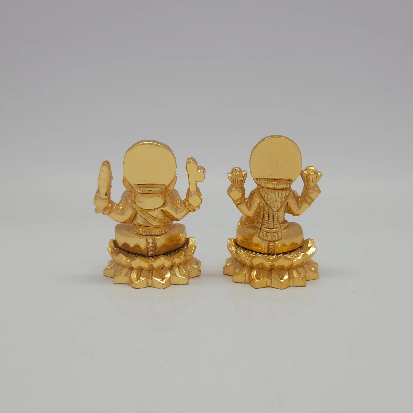 Rear view showcasing the detailed back engraving of the 5cm gold powder-coated decorative brass Ganesha statue from sriswaminathan.com