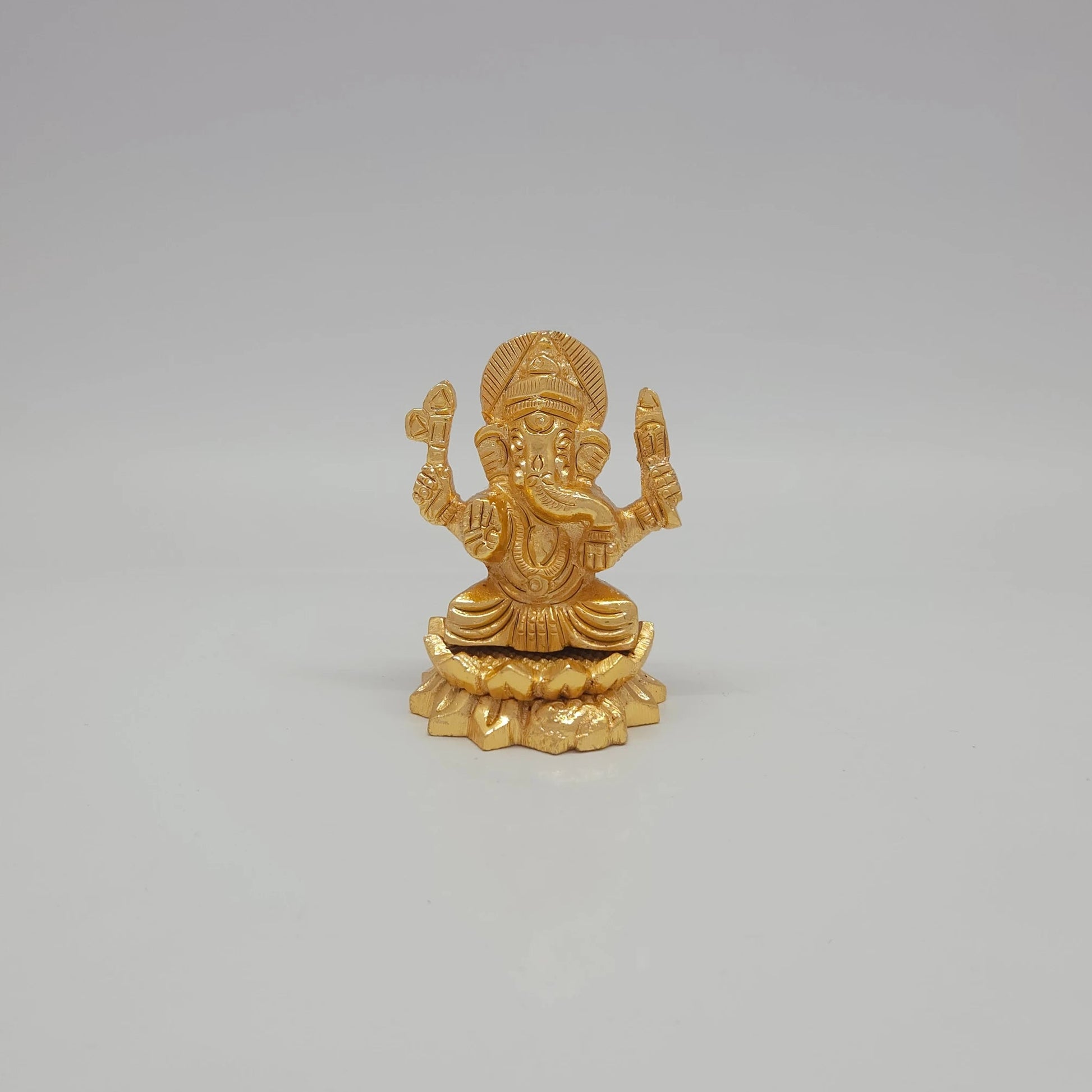 Front view of the 2-inch gold powder-coated brass Ganesha sitting lotus decorative figurine by Sri Swaminathan & Co