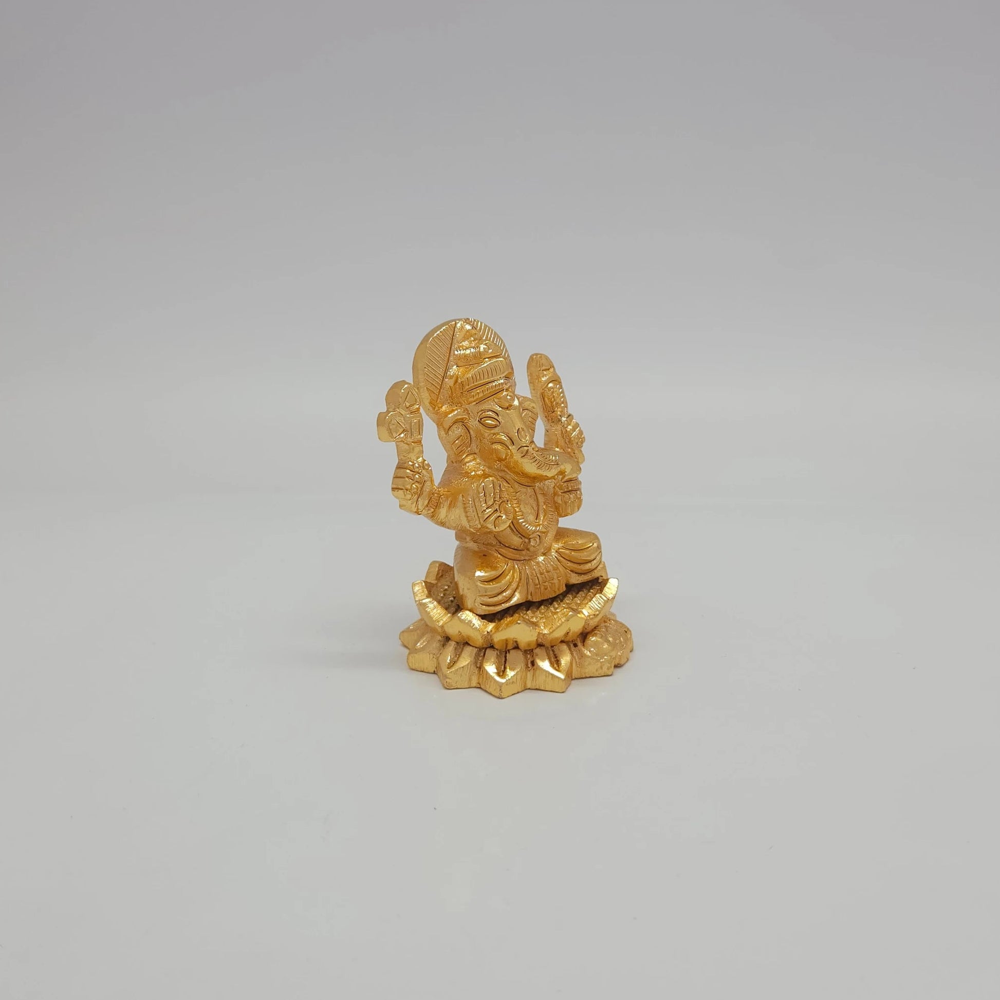 Right 45-degree perspective of the premium gold powder-coated metal Ganesha decor ornament available globally at Sri Swaminathan & Co