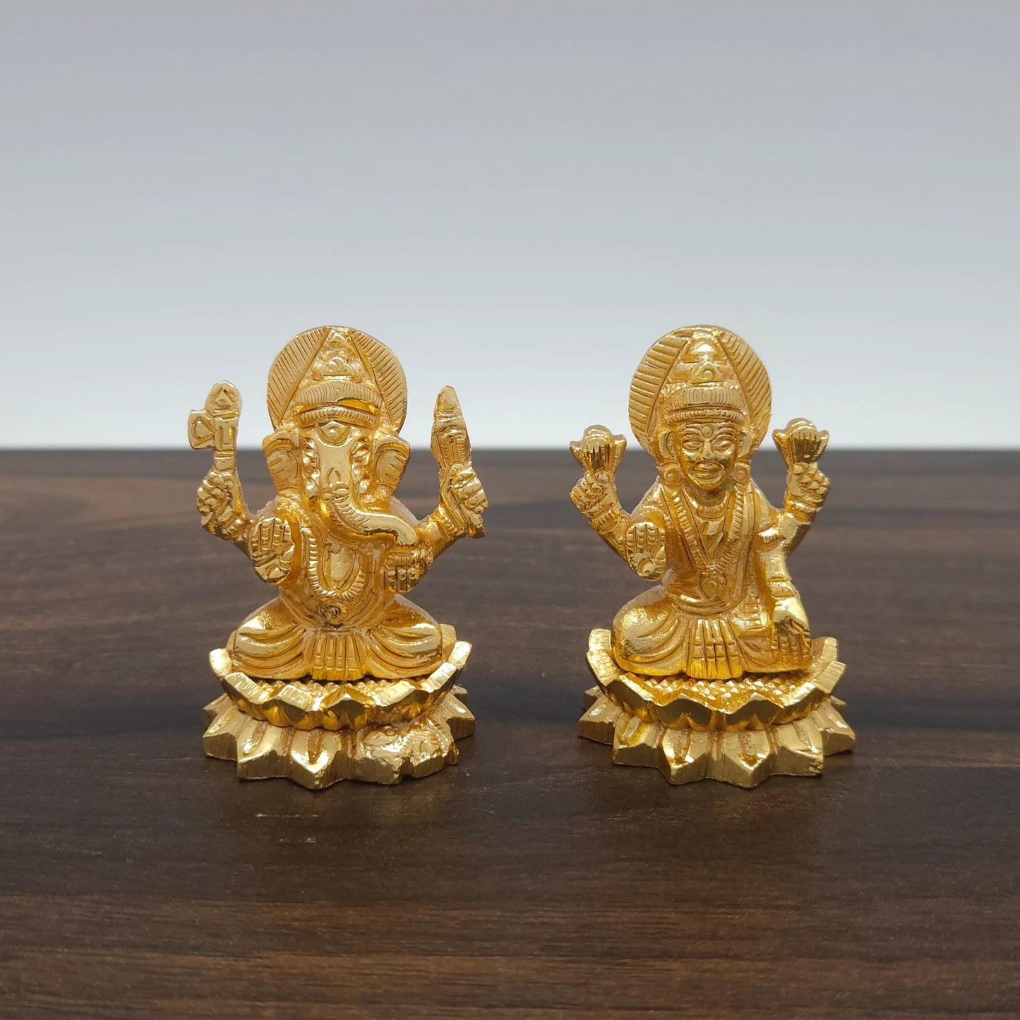 Front view of the 2-inch gold powder-coated brass Lakshmi Ganesha sitting lotus decorative figurine by Sri Swaminathan & Co