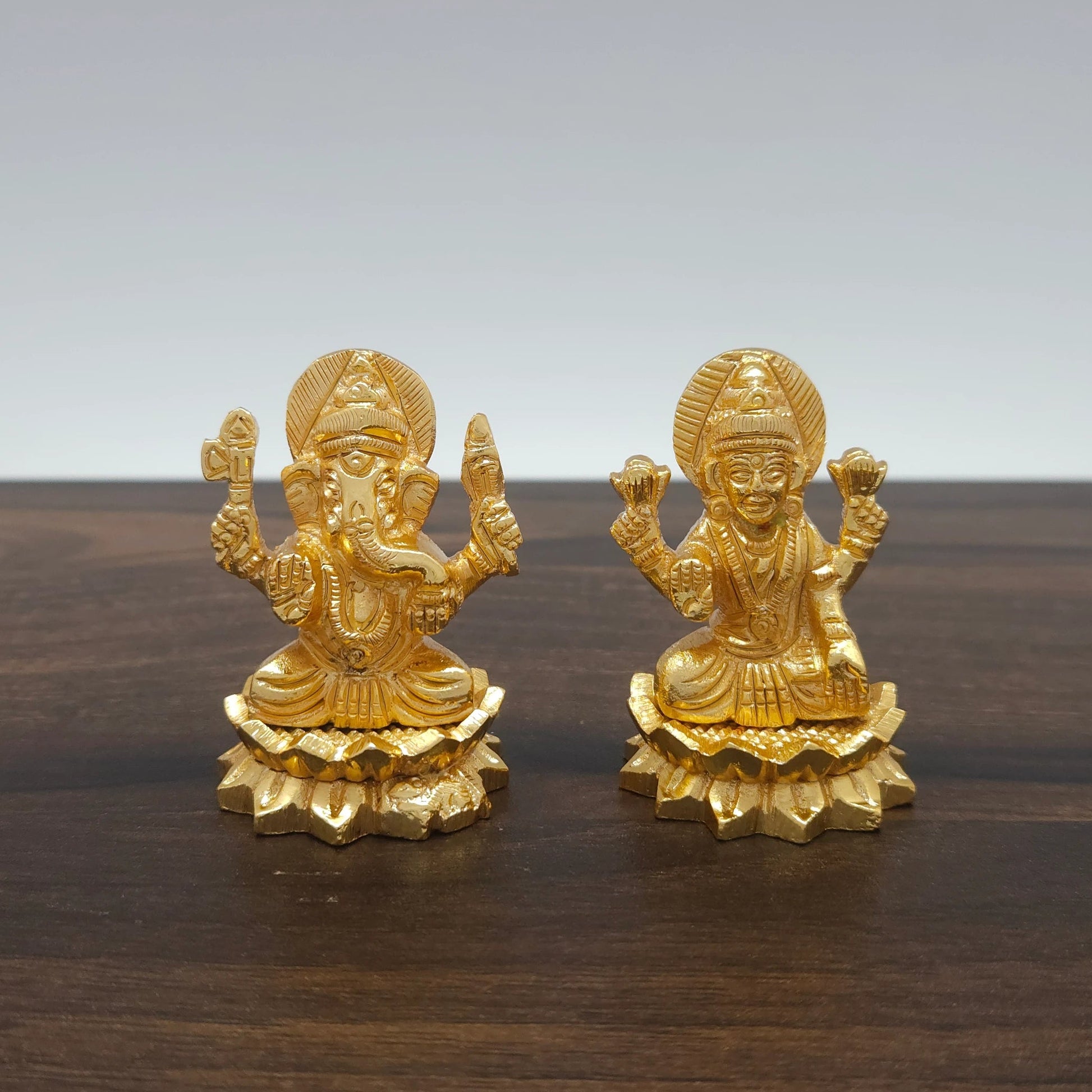 Front view of the 2-inch gold powder-coated brass Lakshmi Ganesha sitting lotus decorative figurine by Sri Swaminathan & Co