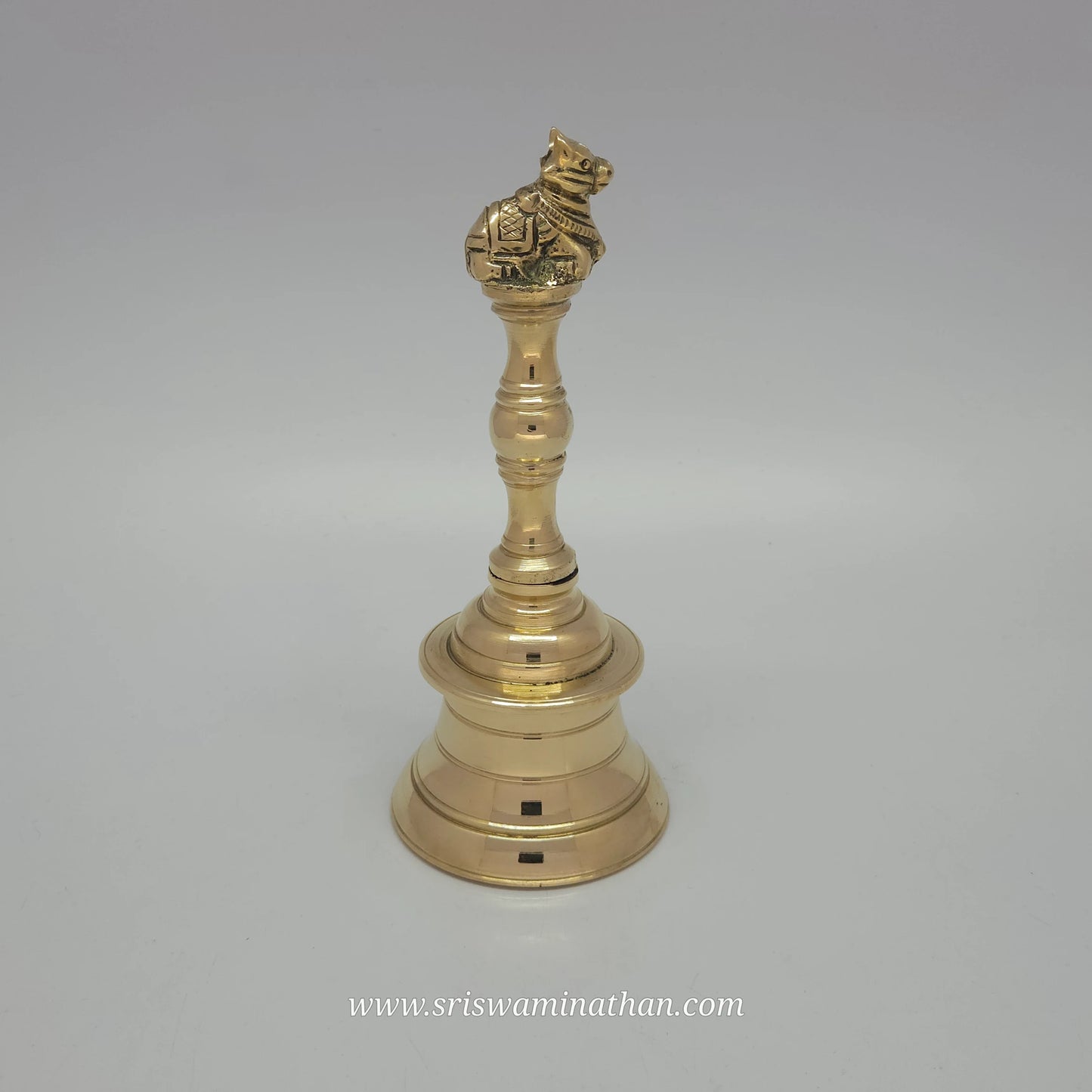 Side view of Nandhi brass bell showcasing traditional temple design and divine sound quality