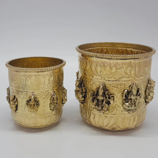 Front view of the Pavithra Amrit Kalash, a heavy 100-percent pure brass multipurpose vessel with intricate embossed figures of Goddess Ashtalakshmi, featuring a polished antique gold finish for home mandir puja and premium decor