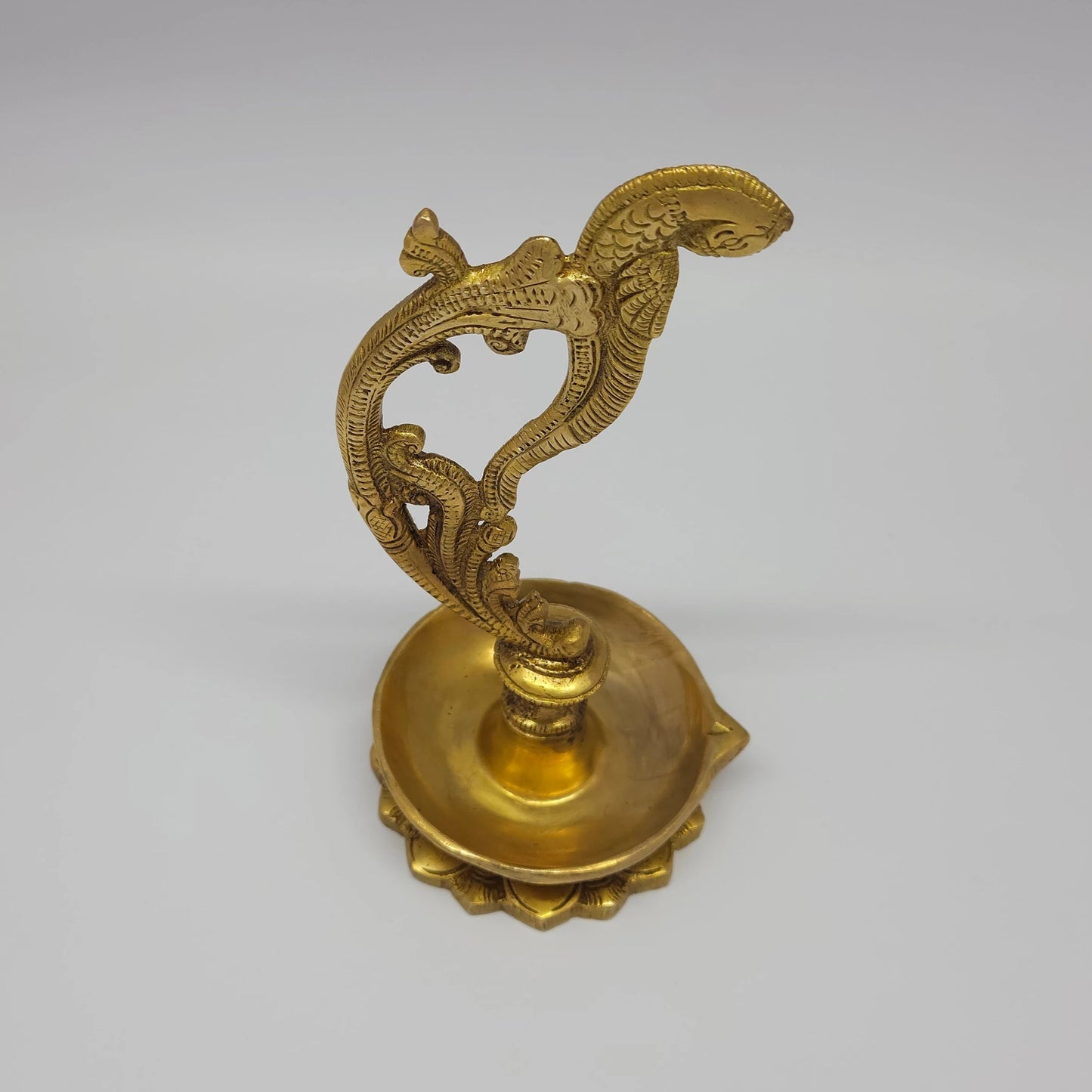 Alt Text Premium Antique Brass Annapakshi hand lamp 8-inch 21cm height top down aerial perspective view showing oil reservoir capacity layout