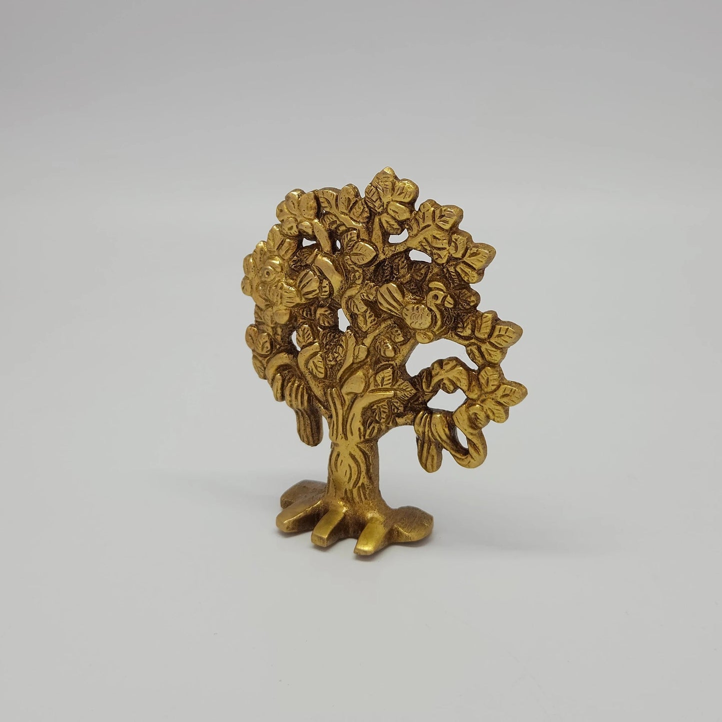 Premium Brass Kalpavriksha tree of life statue 4 inch 9.5cm height 45 degree right pose corner view highlighting exposed banyan style roots and active altar use