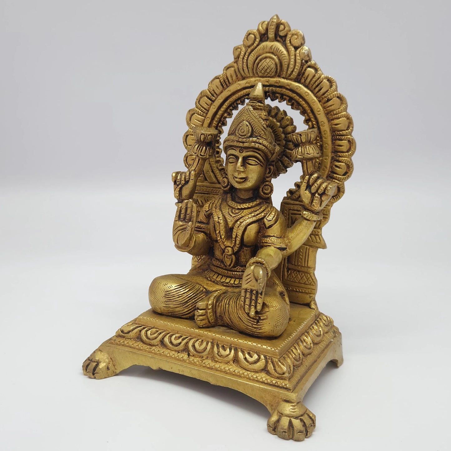 Premium Antique Brass seated Alamelu Mangai Padmavathi Devi statue 18.5cm 45 degree front right corner view focusing on abhaya mudra hand