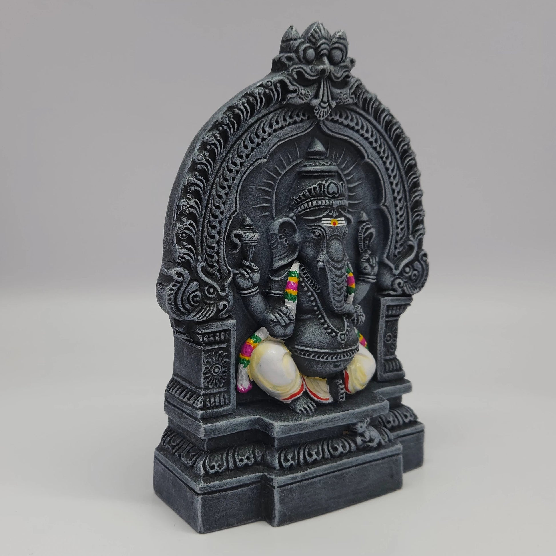 Premium Black stone finish Vinayagar statue 8 inch 19.5cm 45 degree front left corner view highlighting pasha noose and colorful garland