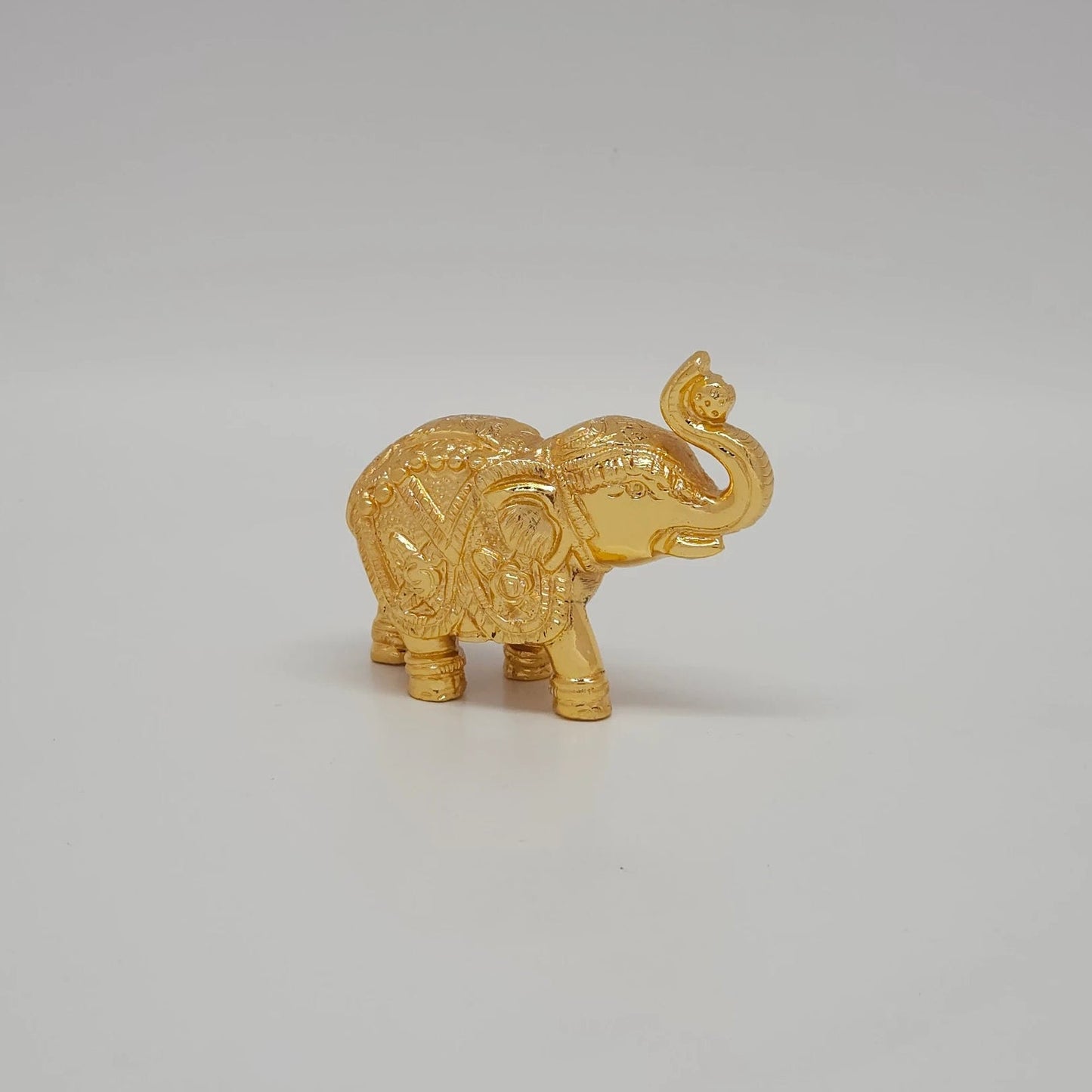Premium Brass Gaja elephant statue raised trunk 9cm length front straight view showing detailed tusks and head adornments