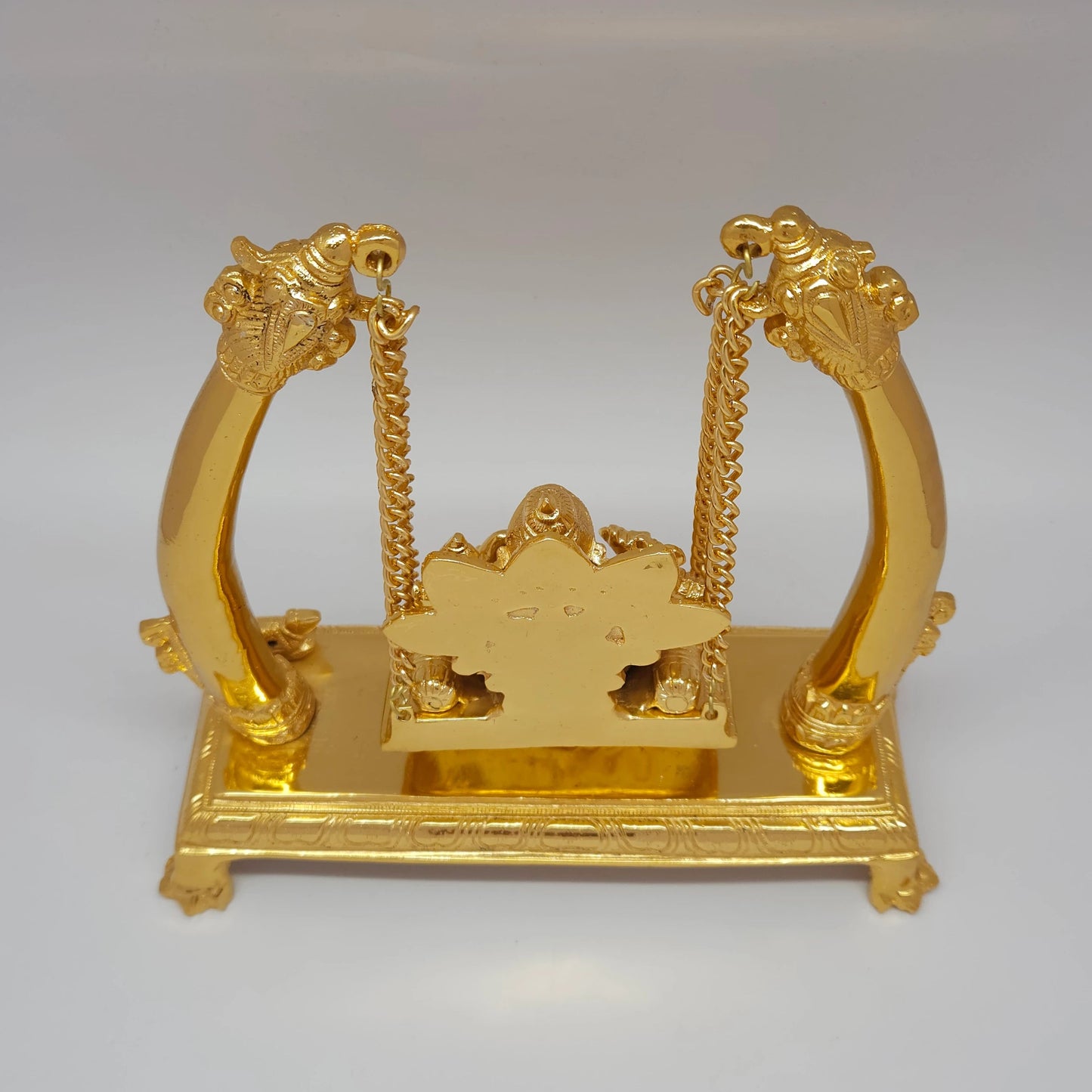 Premium Brass Ganesha Jhula swing statue top angle back view showing upper arch structure and hanging mechanism