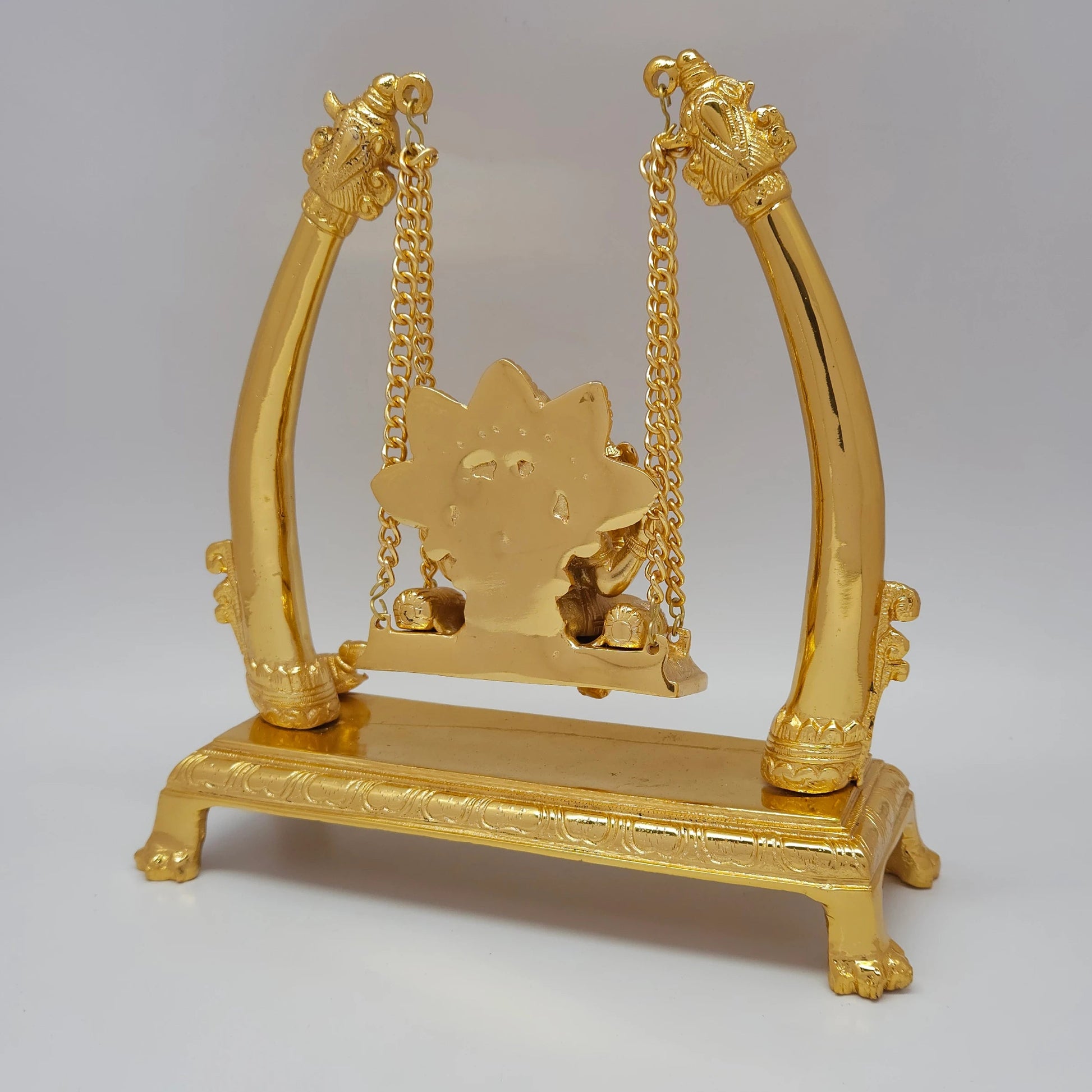 Premium Brass Ganesha Jhula swing statue 27cm back view showing rear arch and solid metal casting structure