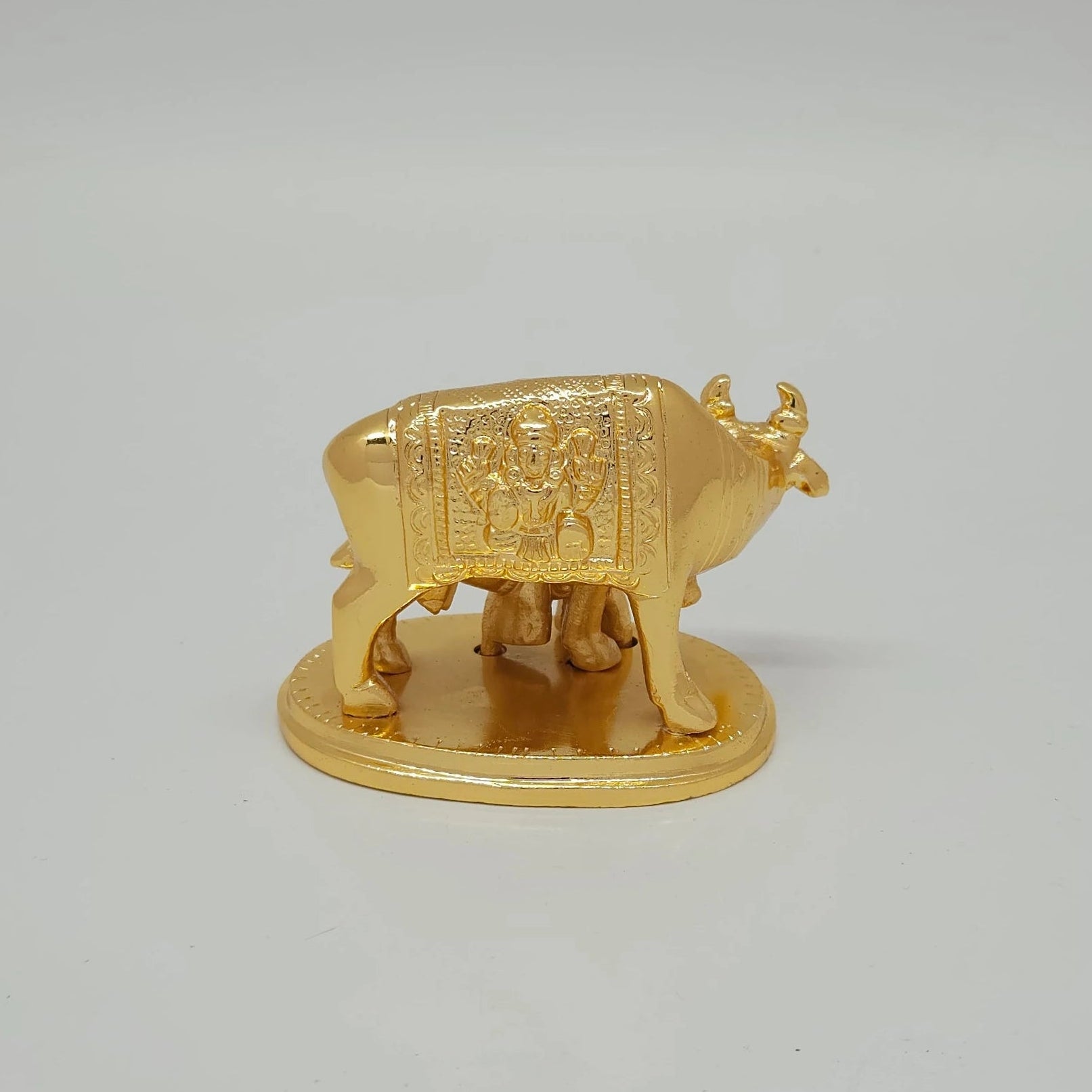 Premium Brass Kamadhenu cow and calf statue 8cm back view showing detailed Lakshmi engraving on saddle