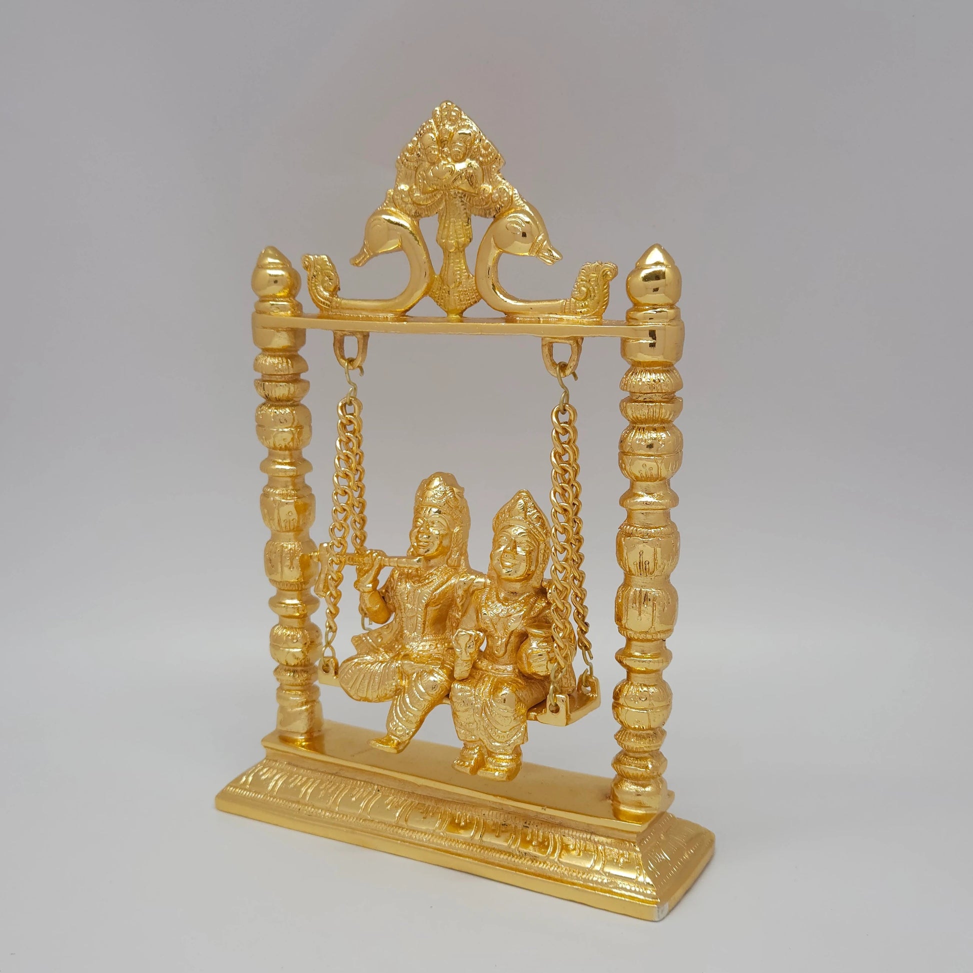 Premium Brass Radha Krishna Jhula swing murti 25cm 45 degree left side angle profile view showing smooth gold finish