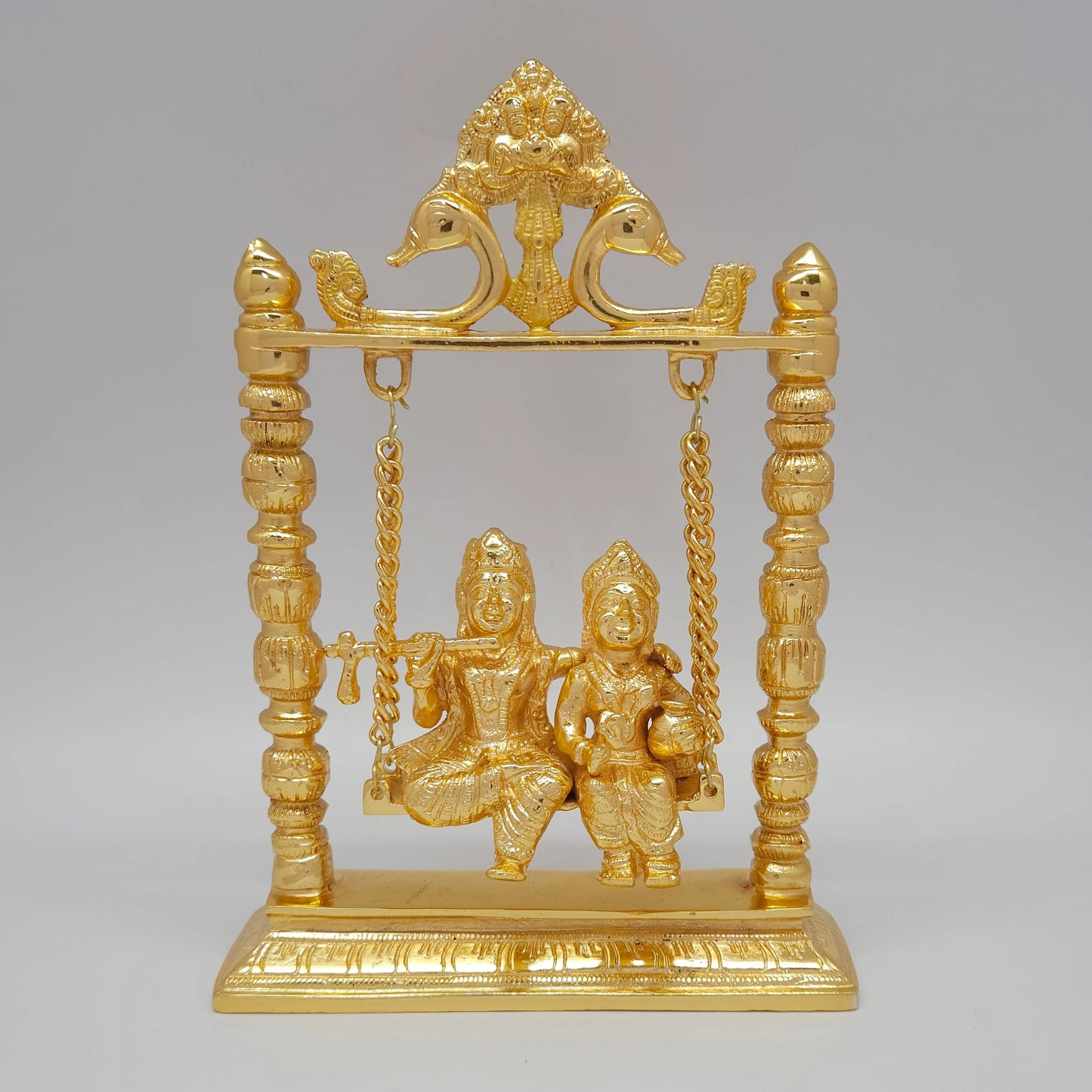 Premium Brass Radha Krishna Jhula swing murti top angle front view showing hamsa swan crest and surface luster