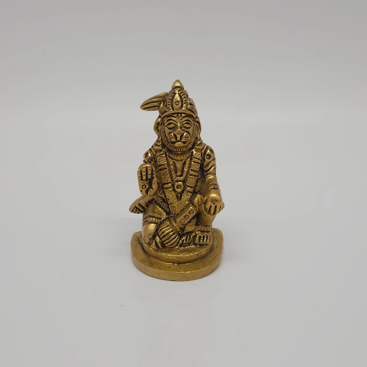 Front straight profile view of the 2.5 inch premium solid brass seated Abhaya Anjaneyar Hanuman statue showing the antique finish layout and blessing hand.