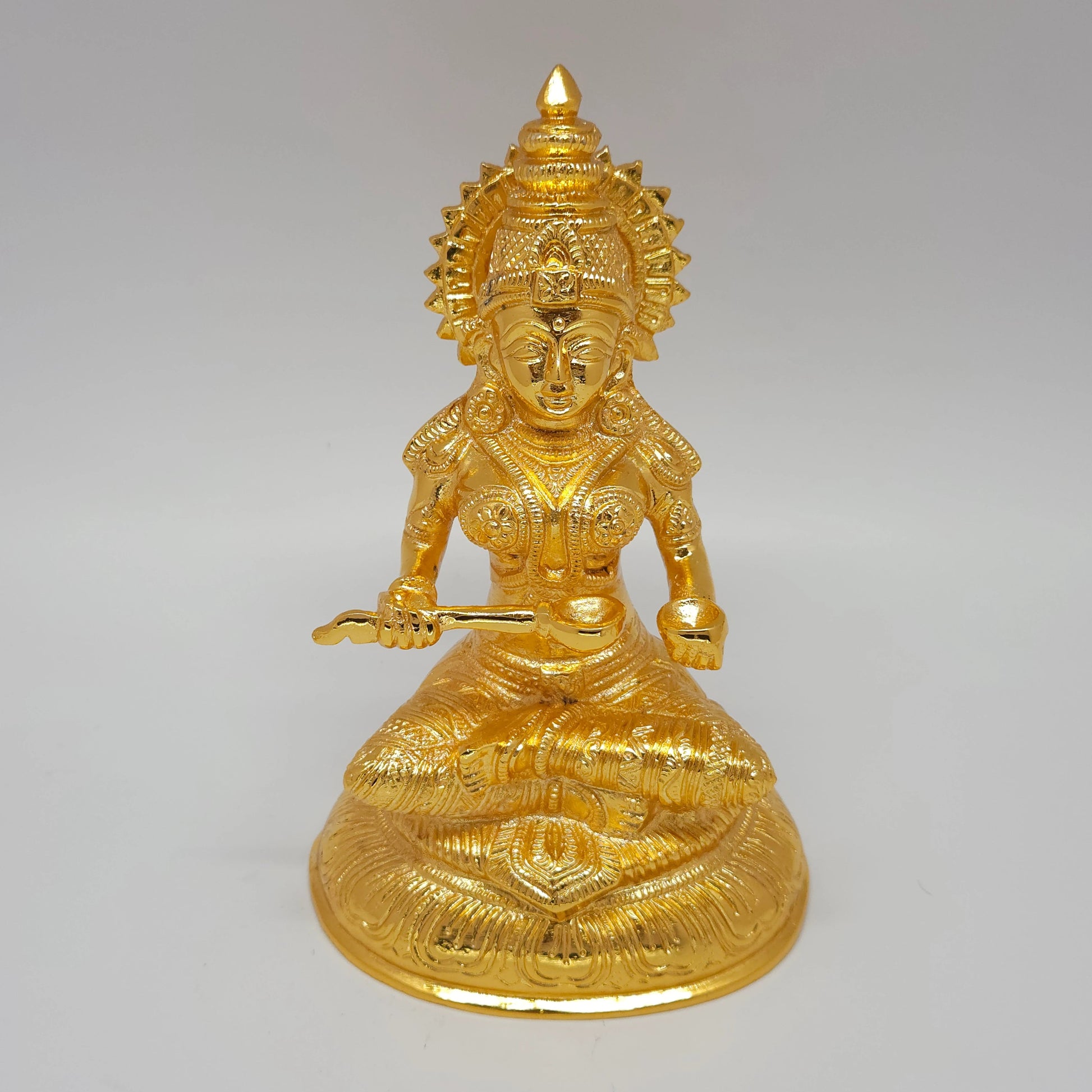 Premium Brass seated Goddess Annapoorani statue 7-inch 19cm height ariel view showing sunburst sirachakra halo and circular base including laddle and bowl