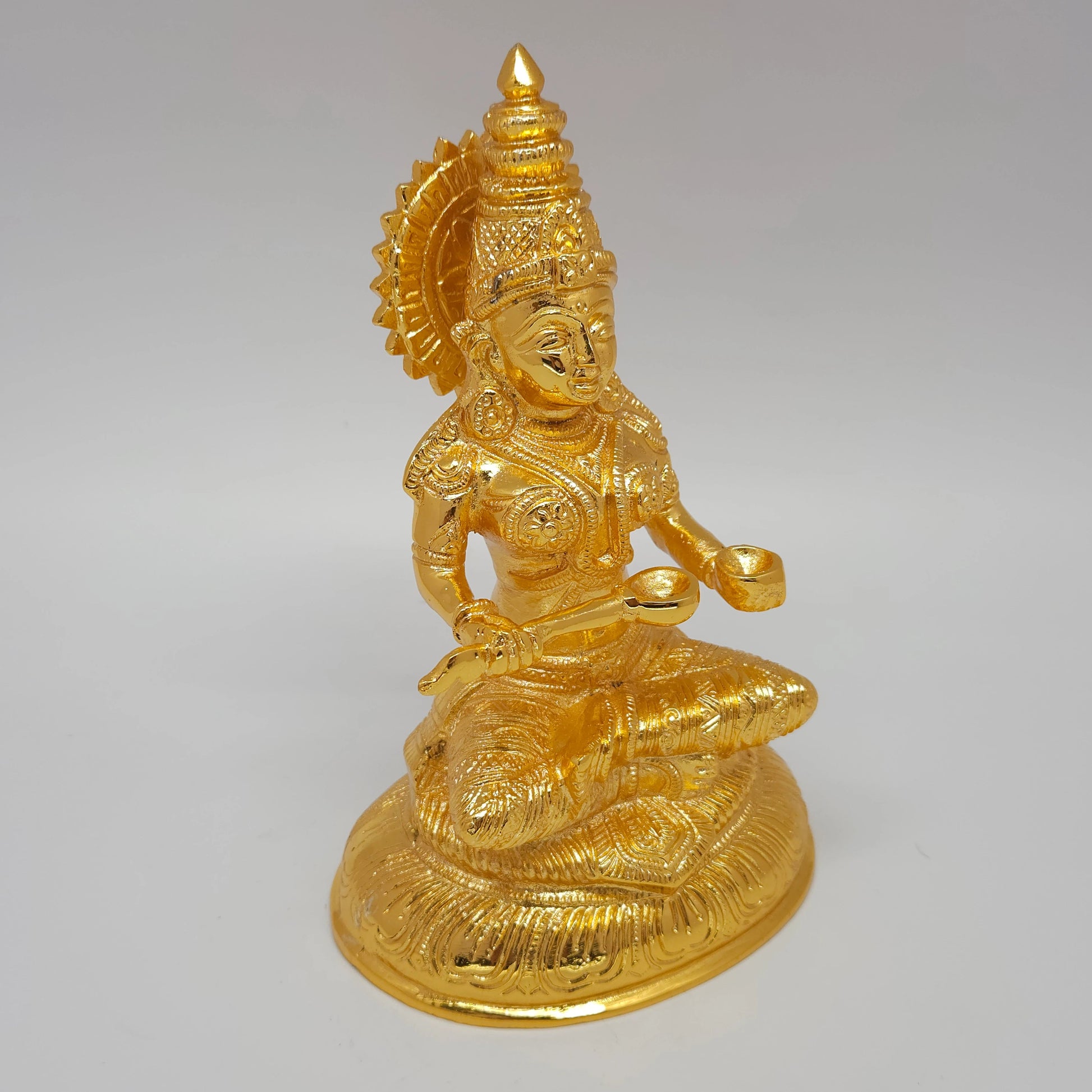 Premium Brass seated Goddess Annapoorani statue 7-inch 19cm height 45 degree left pose corner view highlighting food vessel bowl and crown profile