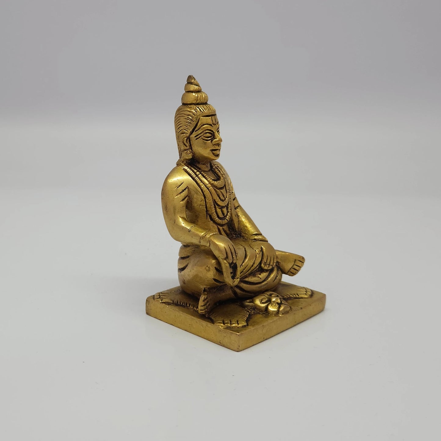 Premium Brass seated Sripada Srivallabha statue 4-inch 10cm 45-degree front left corner view highlighting yoga danda casting profiles