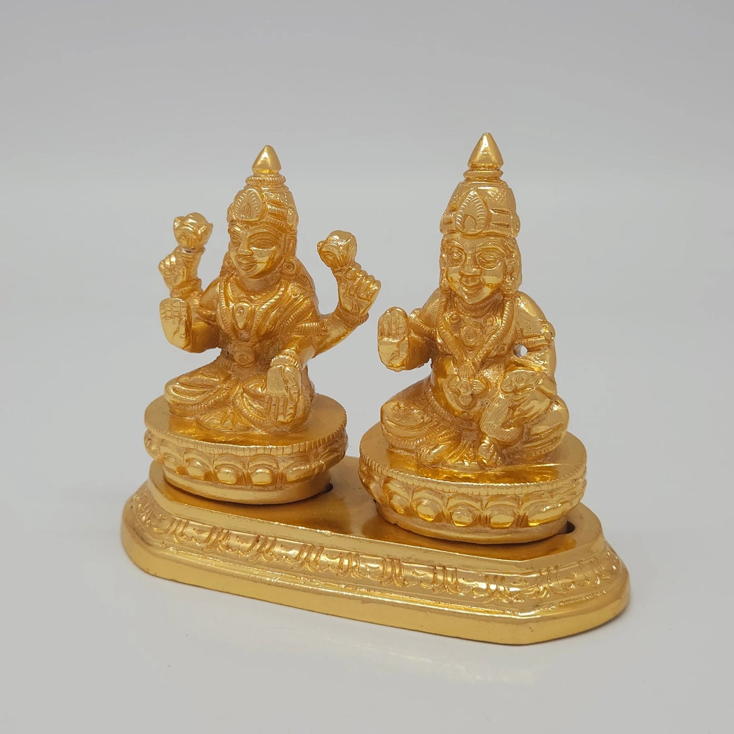Left 45-degree angle profile emphasizing Goddess Lakshmi's lotus details, Kubera's side posture, and the ornate tiered base borders.