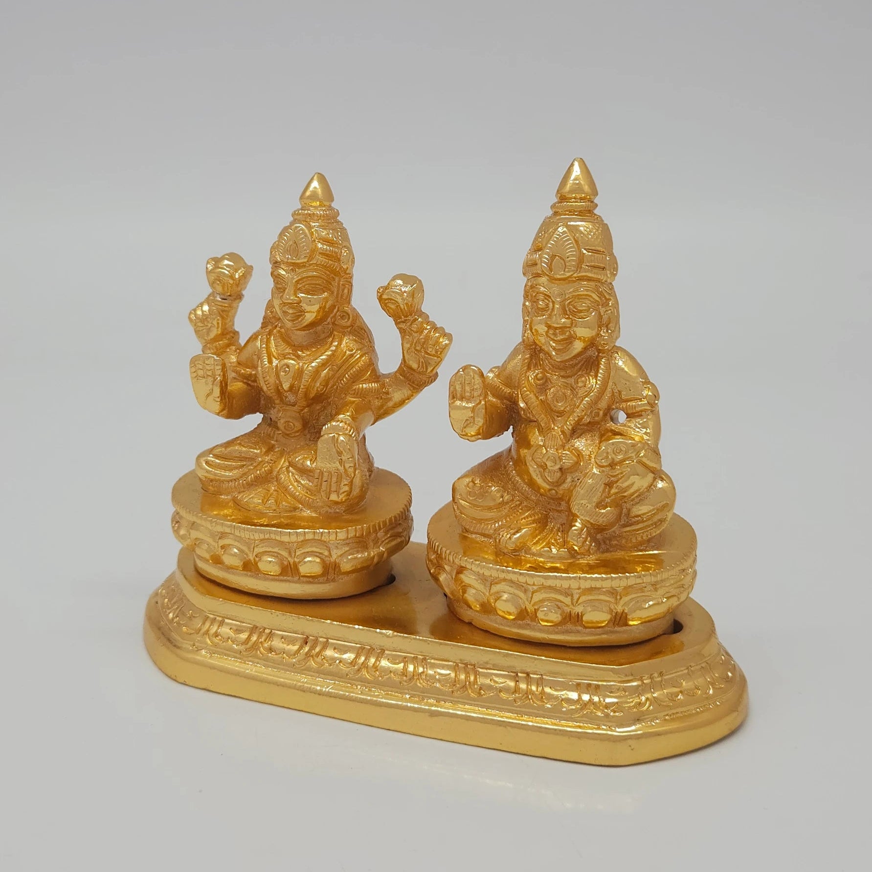 Left 45-degree angle profile emphasizing Goddess Lakshmi's lotus details, Kubera's side posture, and the ornate tiered base borders.
