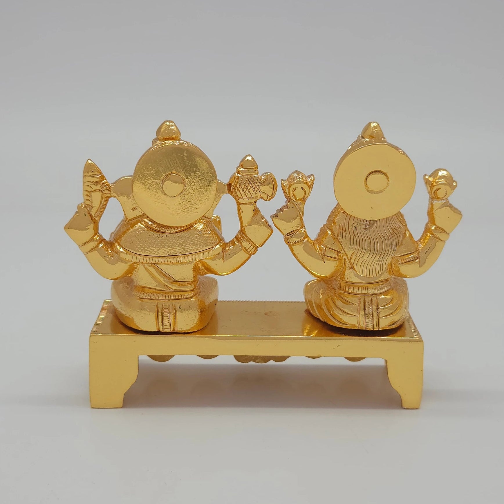 Rear view showcasing the solid back structure of the crowns, the polished reverse bench platform, and the flawless mirror-gold luster.