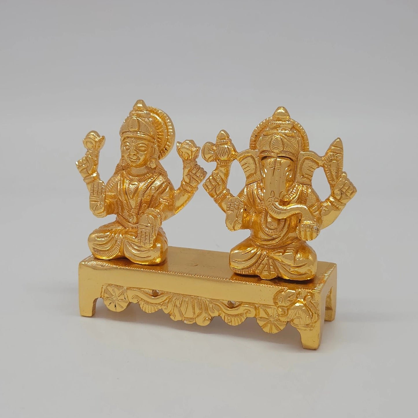 Left 45-degree angle profile emphasizing Goddess Laxmi's features, lotus details, and the engraved front bench legs.