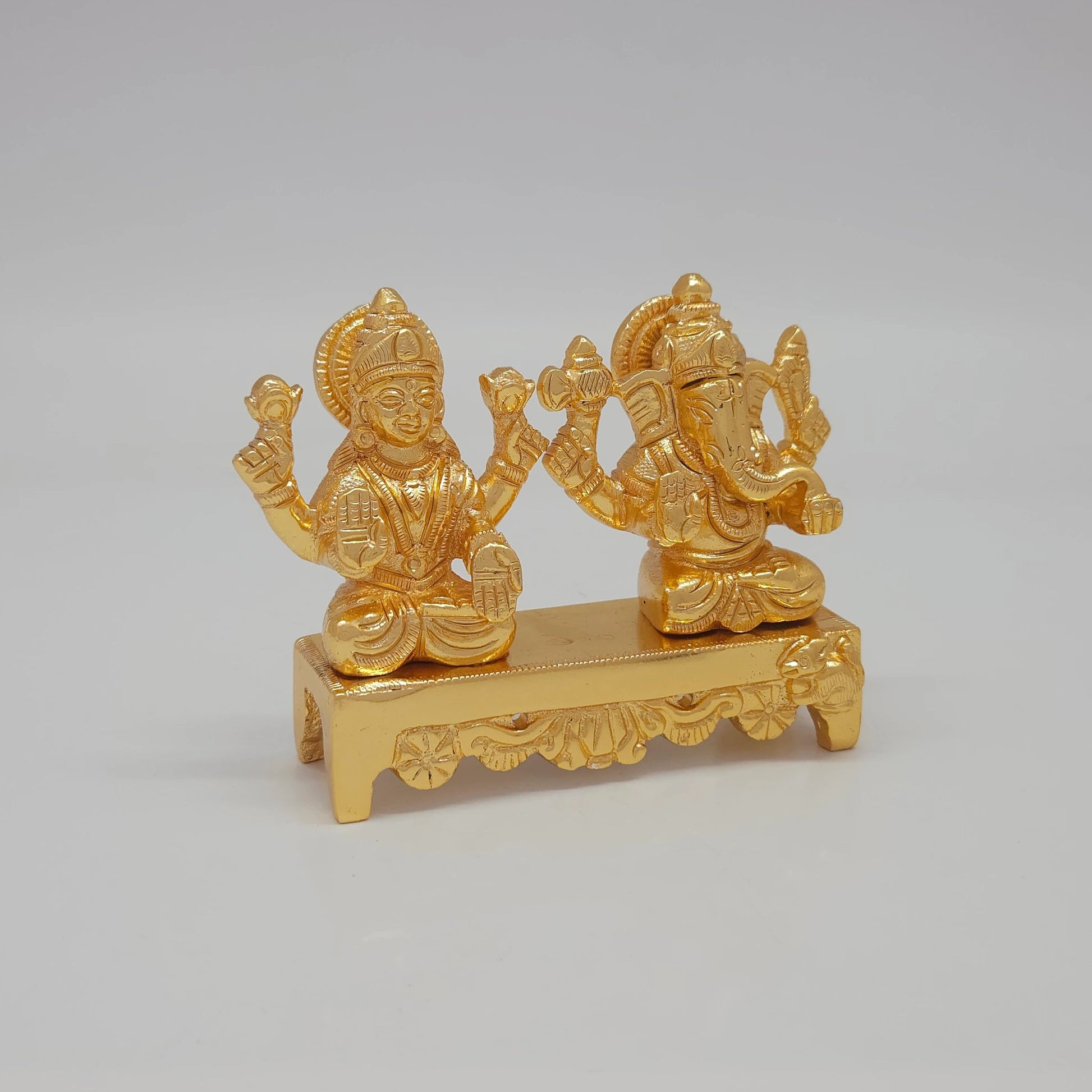 Right 45-degree perspective highlighting Lord Ganesha's trunk contour, the weapon detailing, and the polished metal side boundaries.