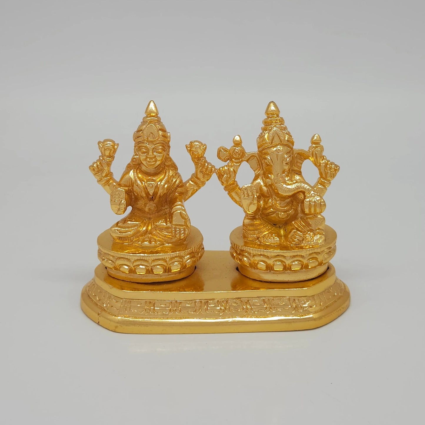 Front view of the 8cm premium gold powder-coated brass Laxmi Ganesha on a shared base platform for luxury home decor.