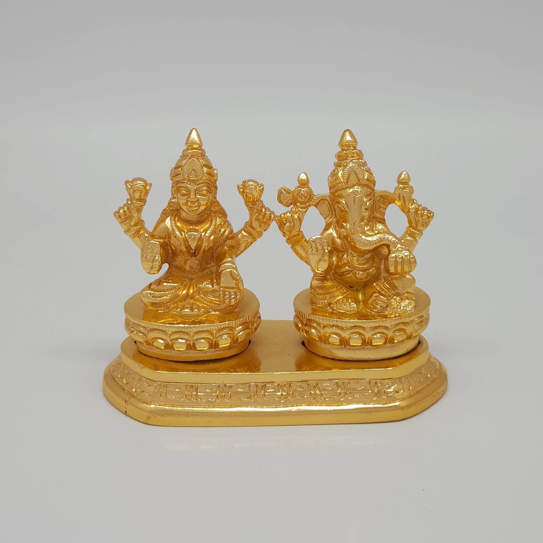 Front view of the 8cm premium gold powder-coated brass Laxmi Ganesha on a shared base platform for luxury home decor.