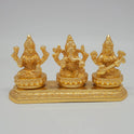 Front view of the 8cm premium gold powder-coated brass Laxmi Ganesha Saraswati trinity on an elongated platform for office front desk decoration.