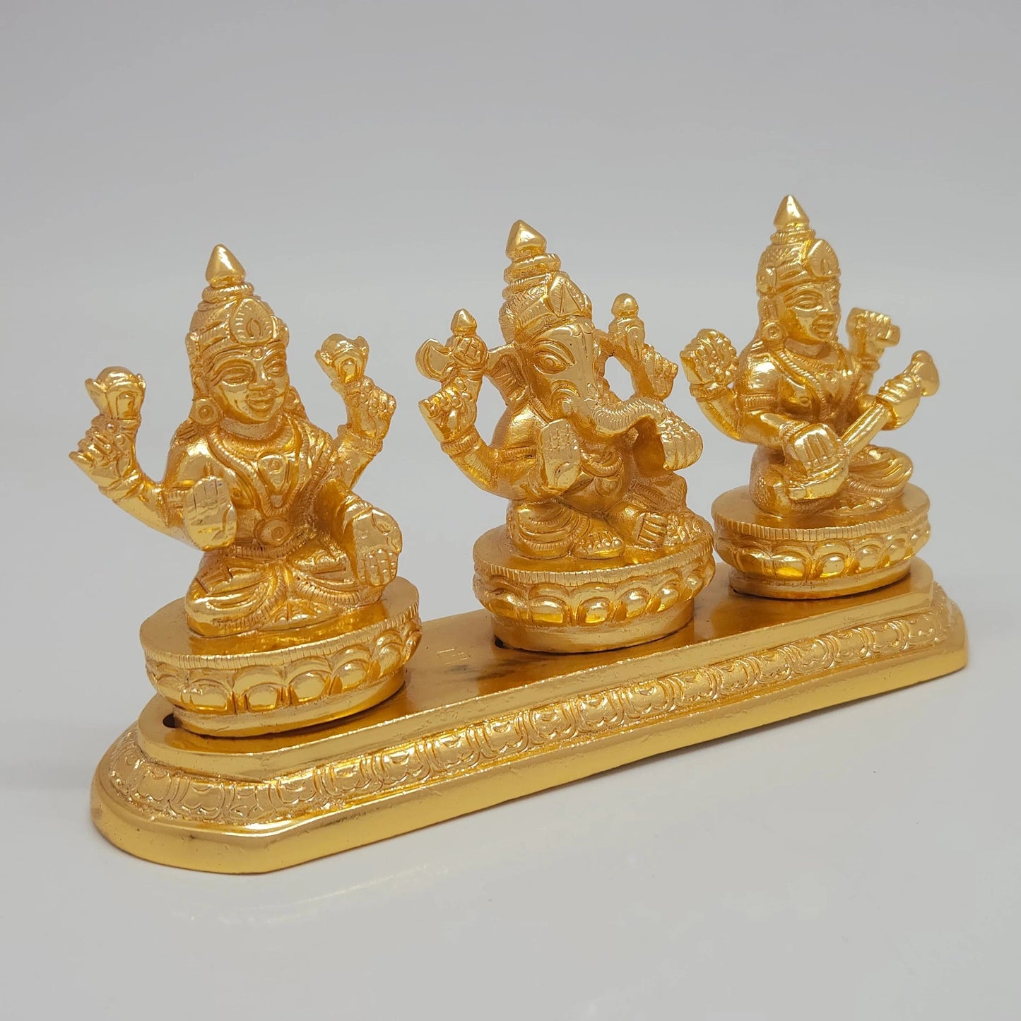 Right 45-degree perspective highlighting Goddess Saraswati holding her Veena, the detailed crown lines, and the polished metal side boundaries