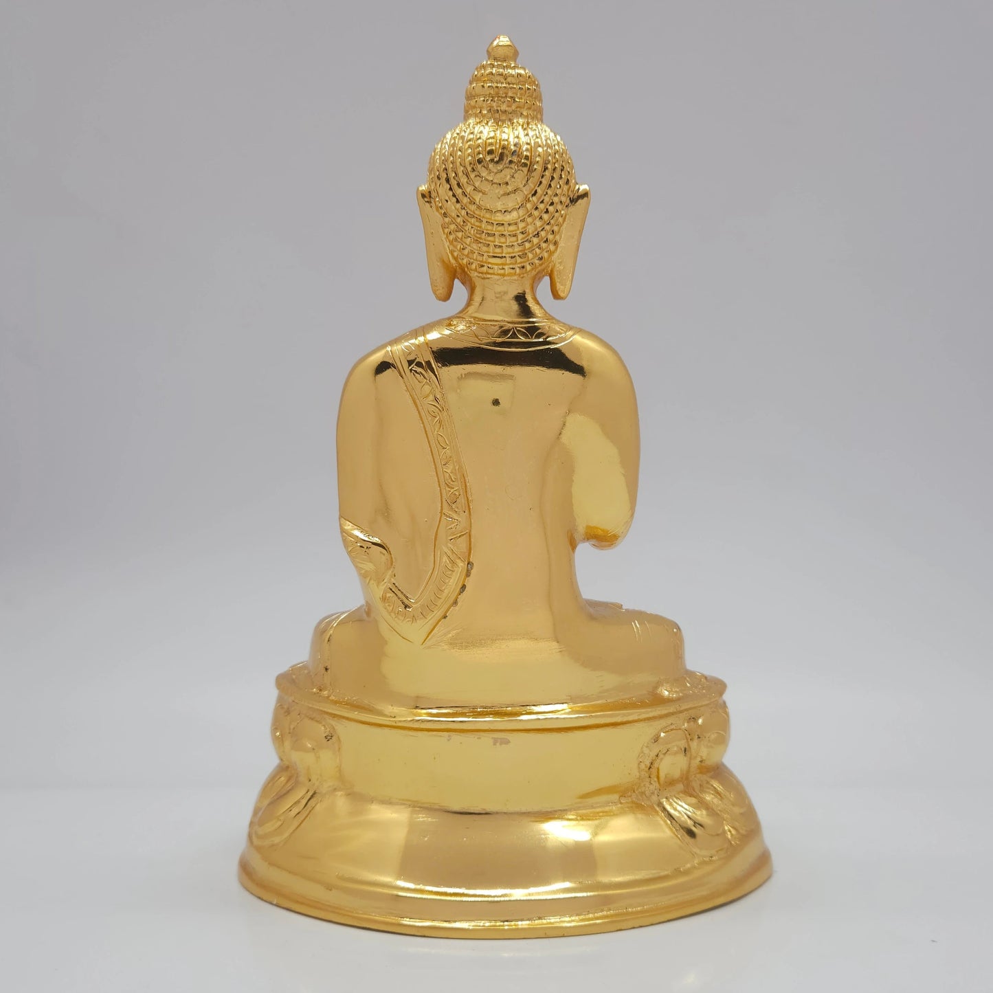 Rear view showcasing the smooth robe styling and polished finish of the 2.2kg decorative brass Buddha statue from sriswaminathan.com