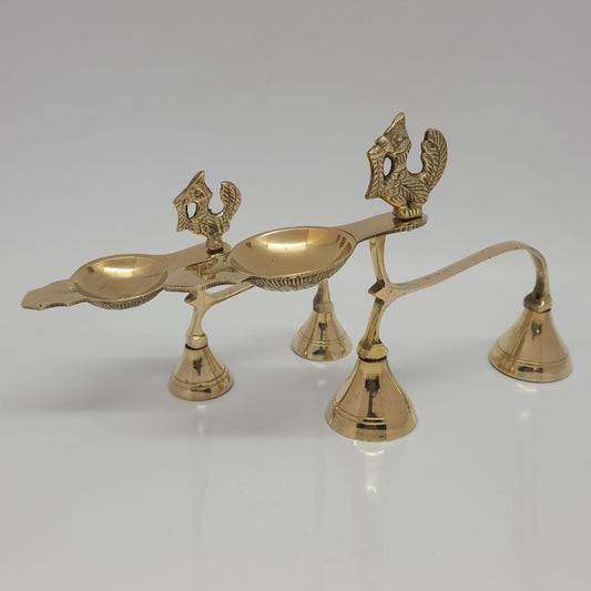 Front perspective view of the small and big variants of the pure brass handheld Annam aarti lamps placed together to show the height and length differences.