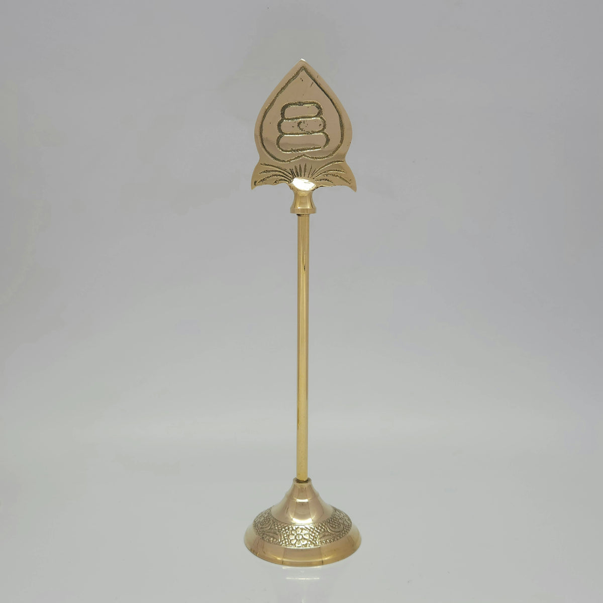 Standing profile of a genuine brass Murugan Vel stand showing the round carved base and smooth golden metal finish