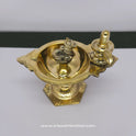 High angle top-down view of the pure brass Shiva Lingam Nandi stand deepam focusing on the wide oil reservoir bowl and yoni details.
