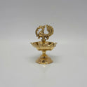A single brass peacock lamp with five wicks for daily home prayers.
