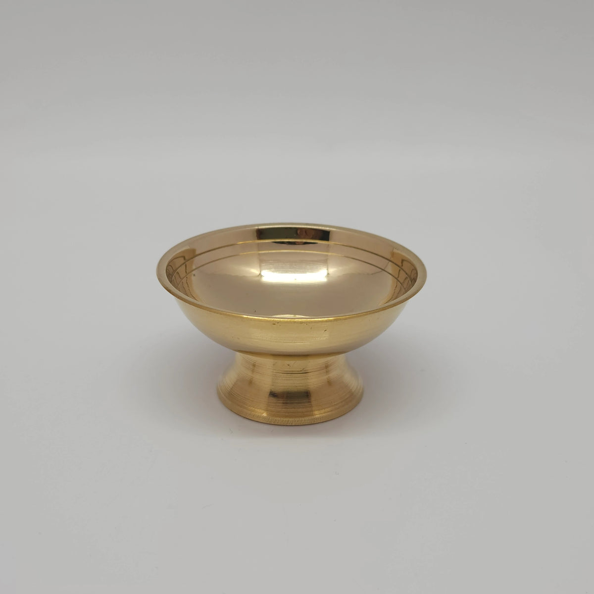 Front view of a single solid brass multipurpose offering cup highlighting the wide flared rim and reflective golden gloss finish