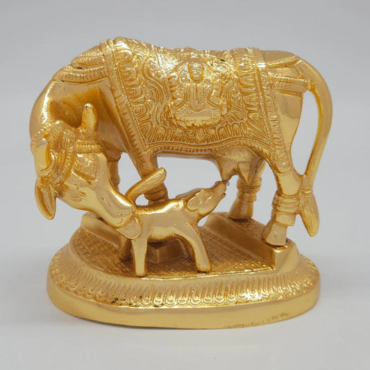 Front view of the 11cm premium gold powder-coated solid brass Kamadhenu cow and calf statue showing the nursing posture and Lakshmi engraving.