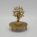 Decorative application sample showing a brass Kalpavriksha tree statue placed elegantly on top of the antique brass tripod chowki pedestal
