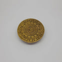Top view of the 10cm antique solid brass circular Chowki pedestal showing the central Om symbol, lotus layers, and Swastika border for daily puja rituals