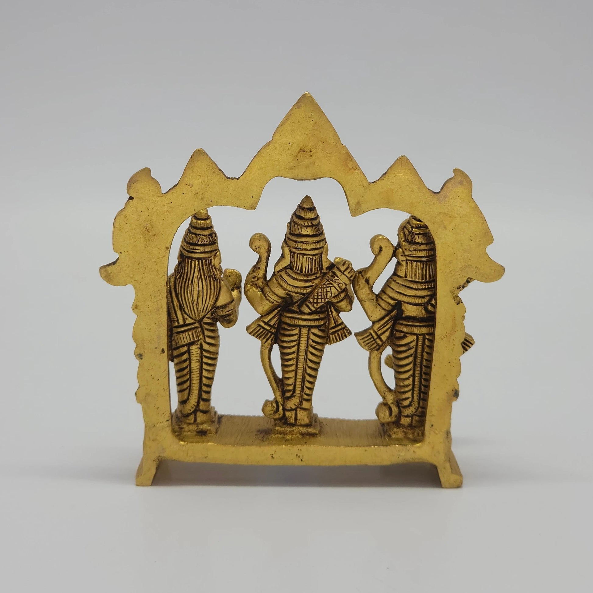 Rear view showcasing the solid back structure of the Suryavanshi arch panel and raw antique brass texture of the 570g idol.